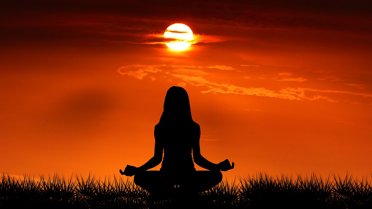 lady meditating on the beach